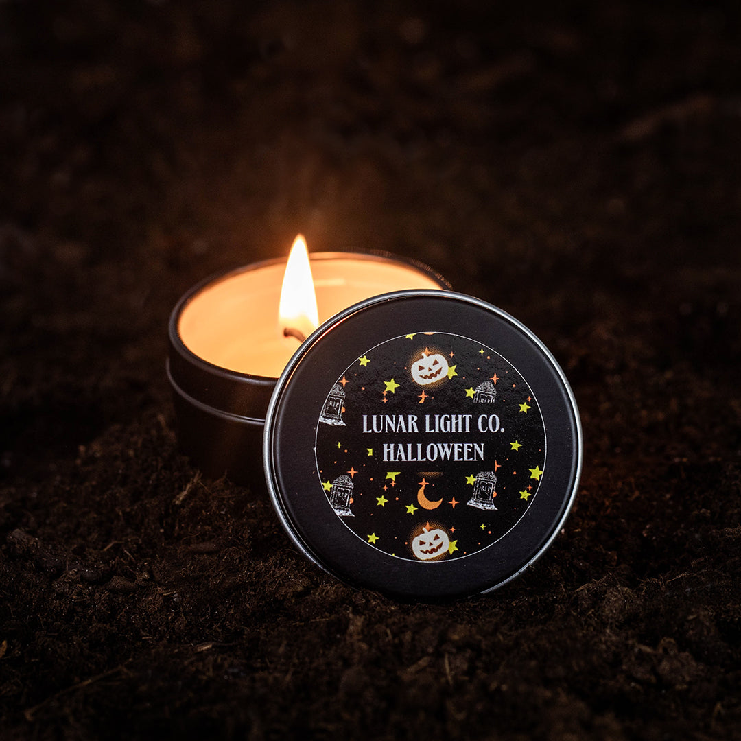 Lighted 2oz Halloween candle on dirt