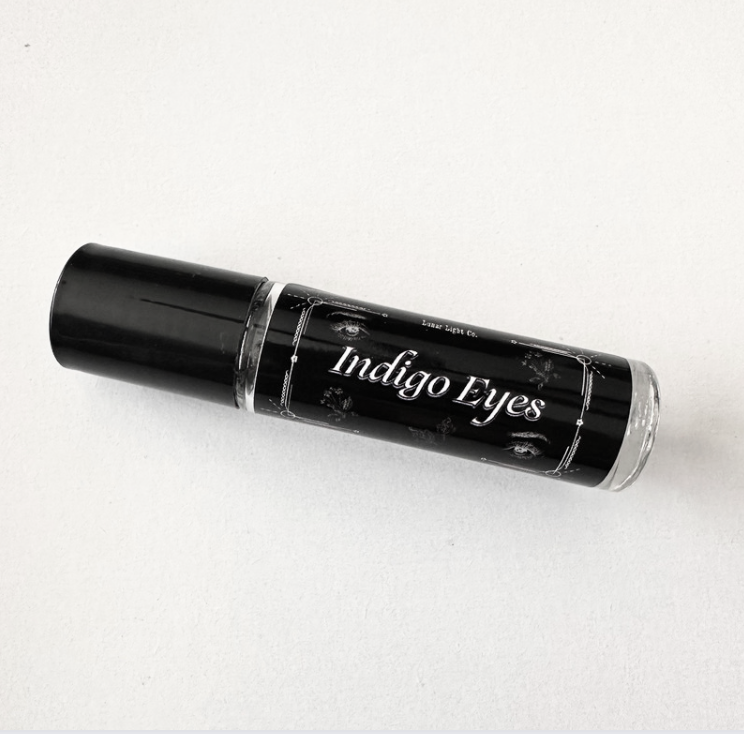Indigo Eyes perfume oil roll on white background