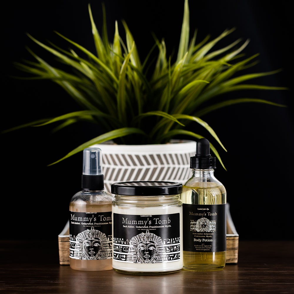 mummys tomb candle, room spray and hair potion with plant