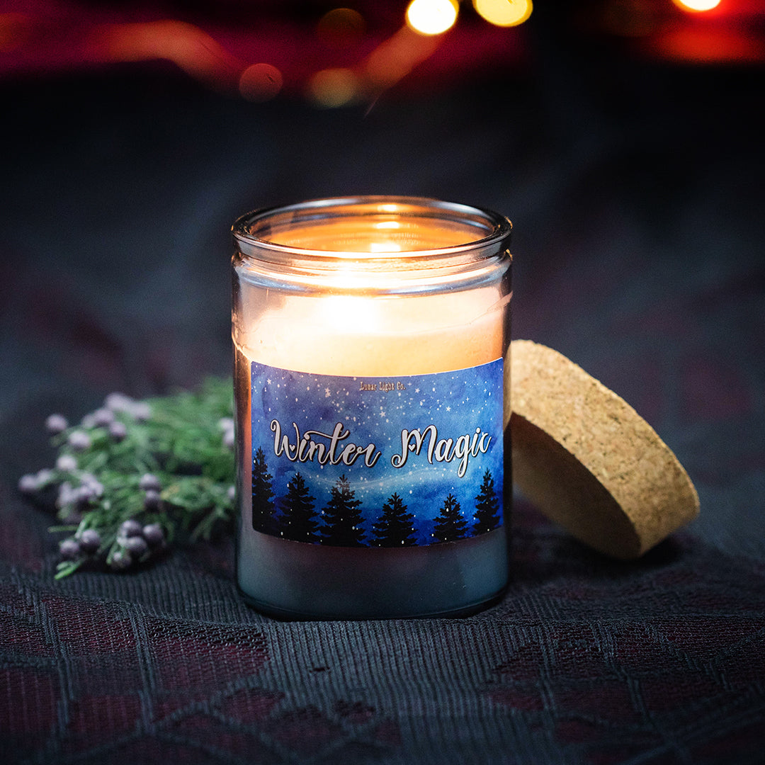 Winter magic candle on black and red tablecloth