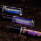 Perfume Oil roll on bottles displayed on dirt. One in focus, 2 out of focus
