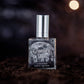 Graveyard Moon eau de parfum bottle displayed on dirt with a foggy, moonlit atmosphere