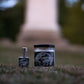 graveyard moon perfume and graveyard moon candle displayed in a cemetery