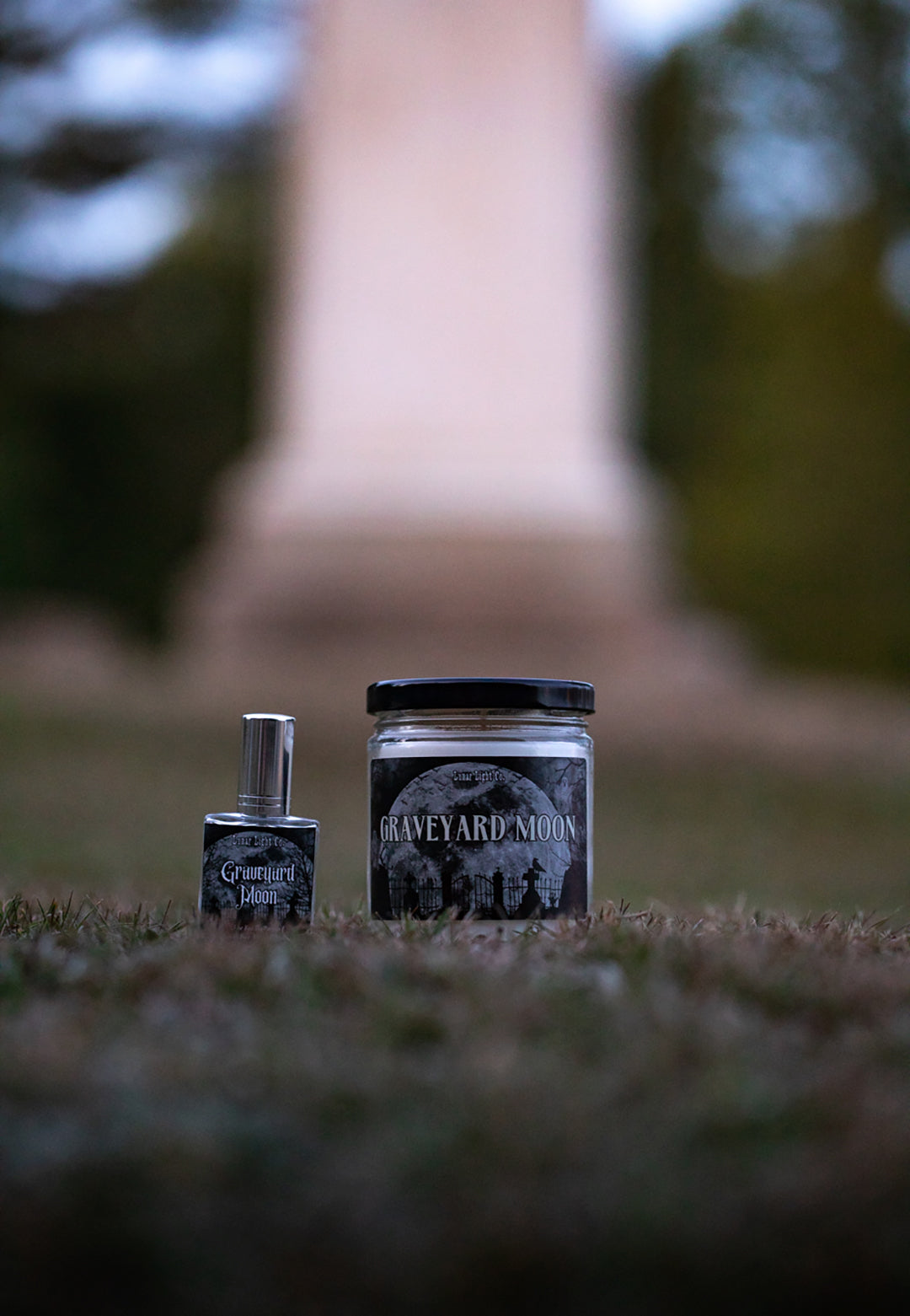 graveyard moon perfume and graveyard moon candle displayed in a cemetery