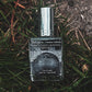 Kings Chapel Winged Skull Gravestone label on a gothic perfume displayed in grass