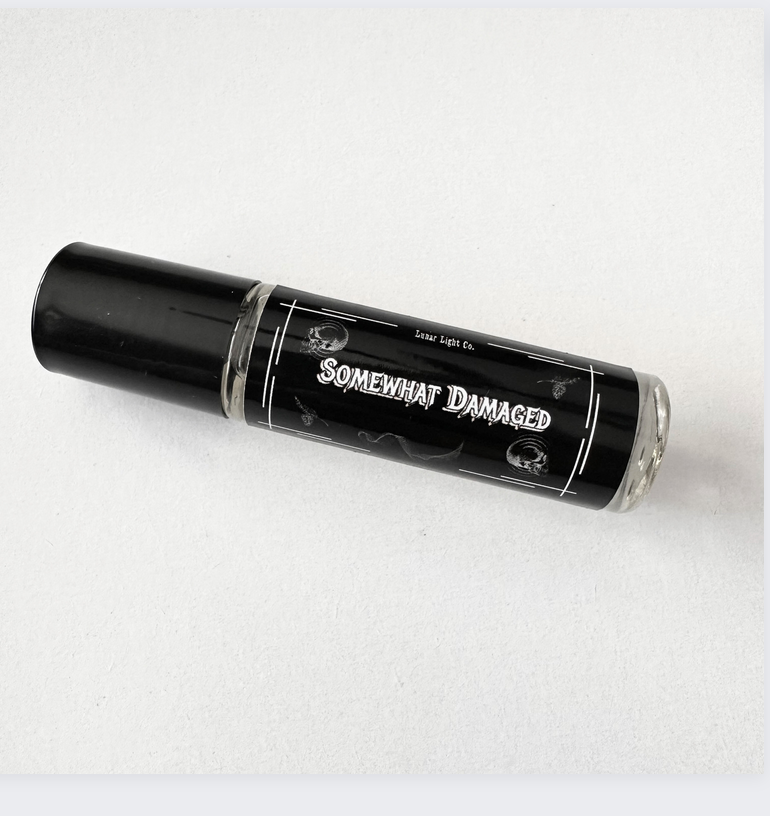 Somewhat damaged perfume oil on white