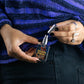 halloween forever perfume with cap off in hand with spooky rings