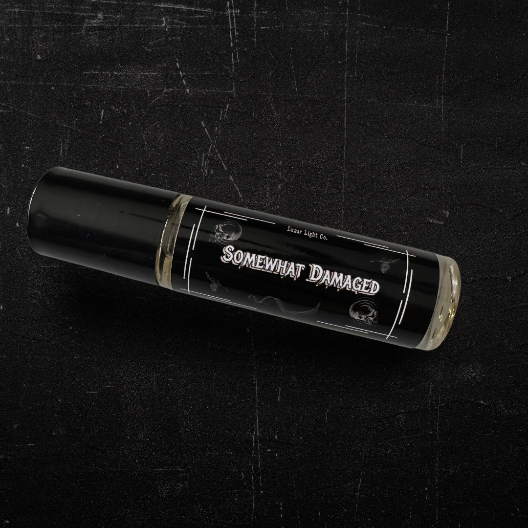 Somewhat damaged perfume oil on black