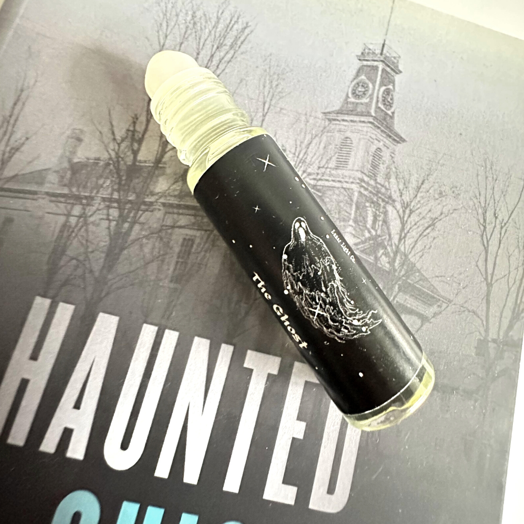 The Ghost Perfume Oil on Book showing roller ball bottle