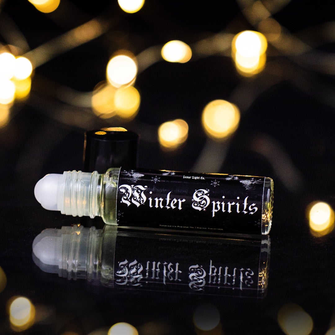 winter spirits perfume oil roll on with twinkle lights in background